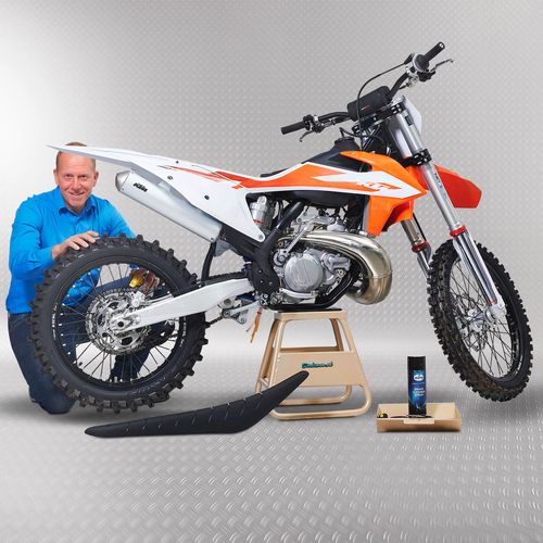 Sleutelen aan de crossmotor die staat op een gouden MX stand